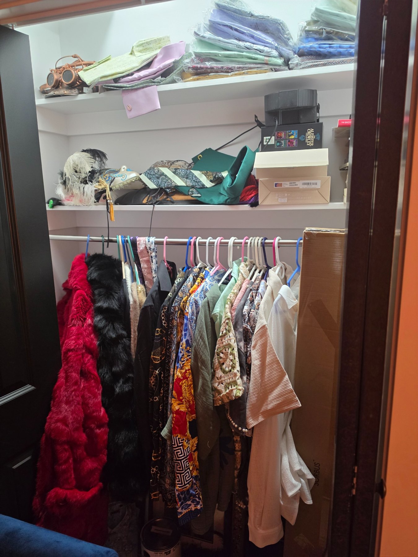 Closet with colorful clothing, hats, masks and fashion items